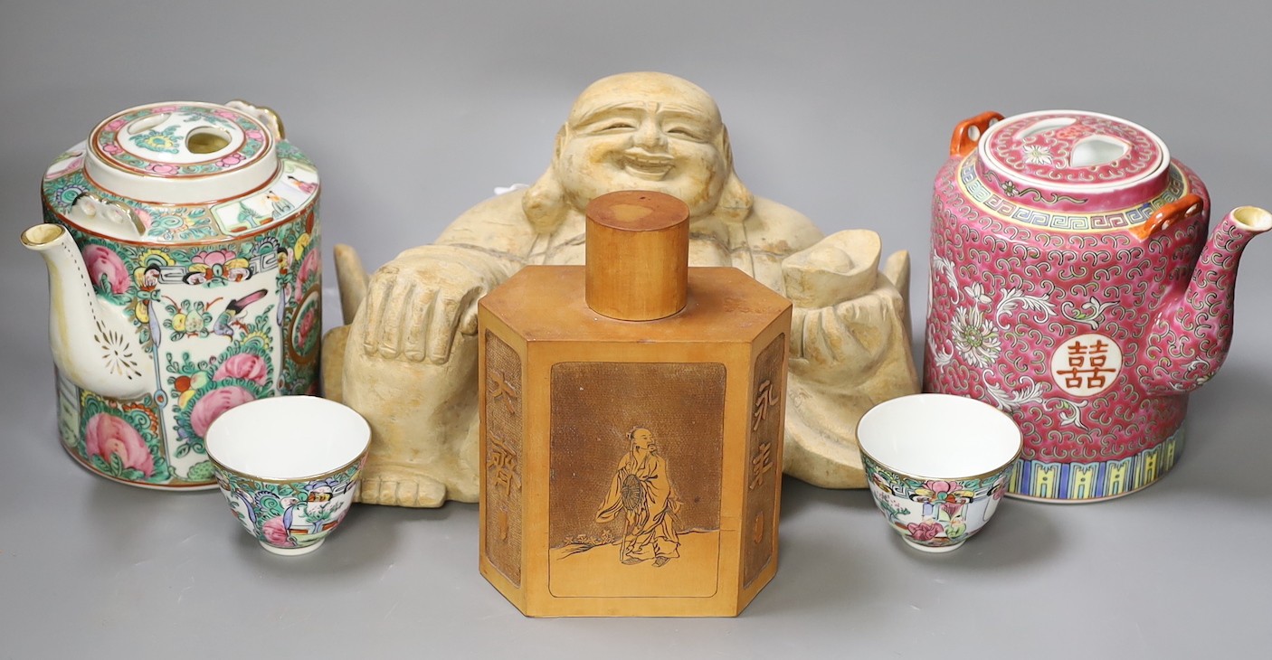 A Chinese wooden figure of Budai, two teapots in baskets and a tea caddy
